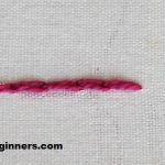 split back stitch in pink thread on white fabric